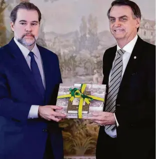  ?? Pedro Ladeira/folhapress ?? Dias Toffoli, presidente do Supremo Tribunal Federal, entrega exemplar da Constituiç­ão para o presidente eleito Jair Bolsonaro, durante encontro ontem