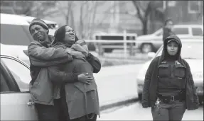  ?? CHRIS SWEDA/CHICAGO TRIBUNE ?? The mother walks away from Chicago police as she worries about her sons Raheem, 19, and Dillon Jackson, 20, at the scene where four people were killed in and outside of a restaurant at the corner of 75th St. and Coles Ave. in Chicago’s South Shore...