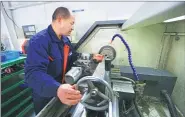 ??  ?? An engineer makes valve core for a multi-point sequential injection control system at Weifang Litro Electrical Technology Company.