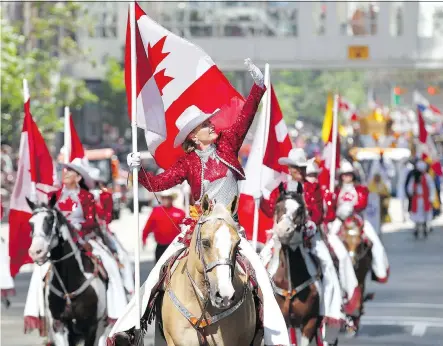  ?? PHOTOS: DARREN MAKOWICHUK ?? The Calgary Stampede Showriders give a Canadian tribute as thousands came out to watch the 105th Calgary Stampede Parade in the city’s downtown to kick off The Greatest Outdoor Show on Earth, Friday.