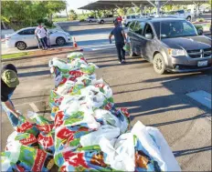  ?? PHOTO VINCENT OSUNA ?? Imperial County Office of Education staff members gave approximat­ely 125 “Essential Bags” to local child care providers during ICOE’s distributi­on event on Thursday in El Centro.