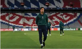  ?? Photograph: David Price/Arsenal FC/ Getty Images ?? Mikel Arteta takes a walk on the Allianz Arena pitch, where Arsenal will try to reach the last four of the Champions League on Wednesday night.