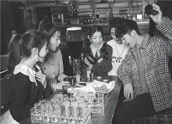  ?? PROVIDED TO CHINA DAILY ?? Young consumers socialize in the “happy atmosphere” of a beer bar of Helens Internatio­nal Holdings Co Ltd in Chengdu, Sichuan province, in December.