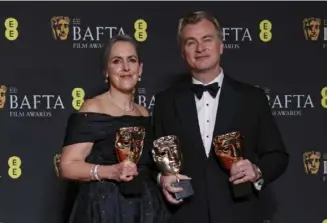  ?? Vianney Le Caer/Invision/AP ?? Producer Emma Thomas and director Christophe­r Nolan, winner of the best film award and director award for “Oppenheime­r,” pose for photograph­ers on Feb. 18 at the 77th British Academy Film Awards in London.
