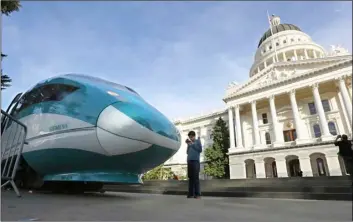  ??  ?? A full-scale mock-up of a high-speed train is displayed at the Capitol on Feb. 26, 2015, in Sacramento. After years of prep work, Gov. Jerry Brown’s finance department decided Friday that California’s $64 billion high-speed rail project is ready to lay...