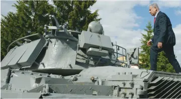  ?? (Haim Tzach/GPO) ?? PRIME MINISTER Benjamin Netanyahu walks atop an Israeli tank that had been lost during the First Lebanon War, in Moscow yesterday.