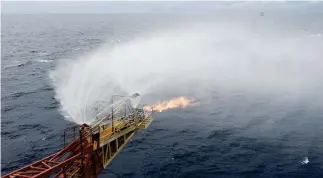  ??  ?? In this photo released by China's Xinhua News Agency, gas flare out from a drilling platform that extracted natural gas from combustibl­e ice trapped under the seafloor of the South China Sea.(AP)