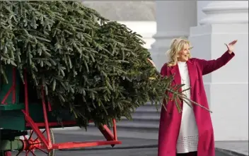  ?? Susan WALSH / AP ?? First lady Jill biden waves to people watching as she looks over the official white House christmas Tree, grown in north carolina, as it arrives at the white House in washington, D.c., on monday.