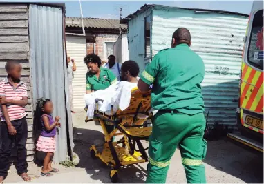  ?? PICTURE: TRACEY ADAMS ?? HELPING HANDS: Medical staff remove a sick man from his shack in Gugulethu after it was reported that he was living in unhygienic conditions and being cared for by his 13-year-old son.