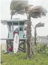  ?? PHOTO: TNS ?? Big blow . . . Dania Beach Ocean Rescue staff secure their surfboard as Tropical Storm Gordon passes by South Florida with wind gusts and heavy rainfall yesterday.