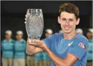  ??  ?? Australia’s Alex De Minaur holds the winner’s trophy after beating Andreas Seppi of Italy in the final of the Sydney Internatio­nal yesterday.