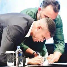  ?? — AFP photo ?? Portuguese defender Pepe signs his new contract with Besiktas on July 5, 2017 at Vodafone Park stadium in Istanbul.