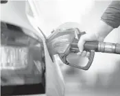  ?? DREAMSTIME ?? Squeezing that last drop of gas into the tank is a bad idea. It is a throwback to when most people paid with cash and tried to avoid getting weird change. Check your owner’s manual for the tank capacity.