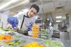  ??  ?? Tunisian chef Bassem Bizid uses edible flowers to prepare his dishes at a luxury hotel in Gammarth, an upscale northern suburb of the capital Tunis.