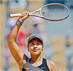  ?? — AFP ?? Japan’s Naomi Osaka celebrates after defeating Romania’s Patricia Maria Tig in the French Open first round match in Paris on Monday.