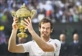  ?? GLYN KIRK / AFP / Getty Images ?? Andy Murray poses with the winner’s trophy after his men’s singles victory over Milos Raonic at the 2016 Wimbledon Championsh­ips.