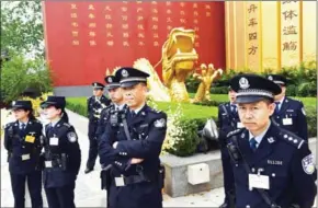  ?? GREG BAKER/AFP ?? Police officers stand guard near a dragon statue after a memorial ceremony for the Yellow Emperor in Xinzheng, in China’s Henan province, on April 9.