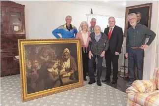  ?? SOURCE: FBI ?? Special Agent Gary France, second right, Dr. Francis Wood and Wood’s children on Thursday in Newark, N.J., stand next to the John Opie painting that was stolen from Wood’s parents’ home in 1969.