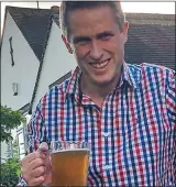  ??  ?? UNDER FIRE: A beaming Gavin Williamson enjoys a pint of beer on a previous break