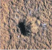  ?? NASA/JPL-CALTECH/UNIVERSITY OF ARIZONA VIA AP ?? Boulder-size blocks of water ice are seen around the rim of an impact crater on Mars.