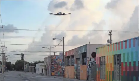  ?? JOE RAEDLE, GETTY IMAGES ?? A plane sprays pesticide over the Wynwood neighborho­od in the hope of controllin­g and reducing the number of mosquitoes.