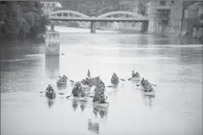  ?? DAVID BEBEE, RECORD STAFF ?? Lynda and Art Alyea lead a group of friends in 12 canoes from the Ancient Mariners Canoe Club down the Grand River in the Galt area of Cambridge on Saturday.