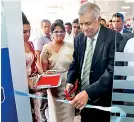  ??  ?? Prime Minister Ranil Wickramasi­nghe formally inaugurate­s Commercial Bank’s 756th ATM while Commercial Bank Personal Banking DGM Sandra Walgama looks on