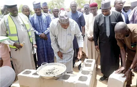  ?? ?? Governor Babagana Zulum ( left) laying the foundation stone for the N5.8 billion flyover bridge project in Maiduguri, Borno State… yesterday.