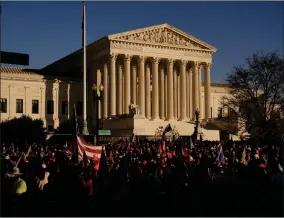  ?? AP PHOTO BY JACQUELYN MARTIN ?? In this Nov. 14 file photo supporters of President Donald Trump attend proTrump marches outside the Supreme Court Building in Washington.