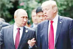  ??  ?? US President Donald Trump and Russia’s President Vladimir Putin talk during the family photo session at the APEC Summit in Danang, Vietnam November 11, 2017. (Reuters)