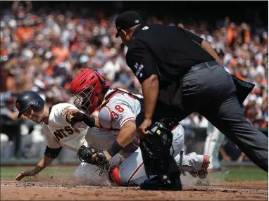  ?? AP PHOTO BY BEN MARGOT ?? Philadelph­ia Phillies catcher Jorge Alfaro (38) tags out San Francisco Giants’ Buster Posey in the third inning of a baseball game, Sunday,, in San Francisco. Posey tried to score on a single by Giants’ Brandon Crawford. At right is home plate umpire...