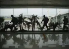  ?? AARON FAVILA — THE ASSOCIATED PRESS ?? Filipino security force members position themselves ahead of the arrival of Malaysian Prime Minister Najib Razak at Manila’s internatio­nal airport, Philippine­s Thursday