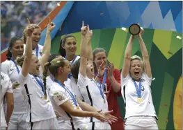  ?? ELAINE THOMPSON — THE ASSOCIATED PRESS, FILE ?? The United States' Megan Rapinoe, right, holds up the trophy after the U.S. beat Japan in the 2015 FIFA Women's World Cup final in Vancouver, B.C., Canada.