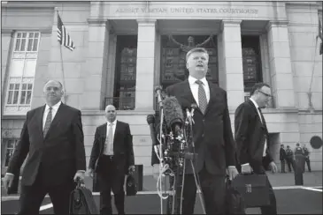  ?? The Associated Press ?? MANAFORT: Defense attorney Kevin Downing, second from right, makes a statement to the media after leaving federal court in the trial of former Donald Trump campaign chairman Paul Manafort, in Alexandria, Va., Tuesday. The defense has rested their case. With Downing are members of the defense team for Manafort, from left, Thomas Zehnle, Jay Nanavati and Brian Ketcham.