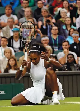  ?? THE ASSOCIATED PRESS PHOTOS ?? Serena Williams slips during her second-round match against Christina McHale on Friday at Wimbledon. Williams dropped the first set 6-7 (7) before rallying to win the final two sets.