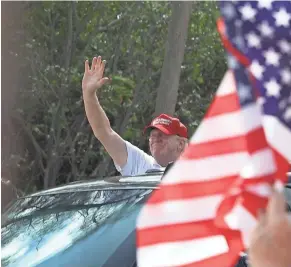  ?? GETTY IMAGES ?? President Donald Trump waves from his vehicle as he stops while being driven past supporters near his Mar-a-Lago resort home on Saturday in West Palm Beach, Fla.