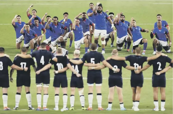  ??  ?? 0 Arm in arm, the Scotland players front up to the Siva Tau, Samoa’s version of the pre-match haka.