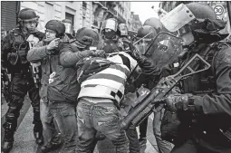  ?? CHRIS MCGRATH/GETTY ?? Some 10,000 protesters, mostly from the yellow-vested movement, took their anger to the streets of Paris, double the number in the capital last week, the interior minister said.