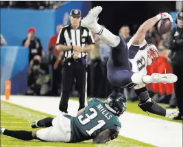  ?? Frank Franklin II ?? The Associated Press Philadelph­ia Eagles cornerback Jalen Mills tackles New England Patriots tight end Rob Gronkowski during the second half. Asked about the possibilit­y of retirement, Gronkowski said he plans to evaluate his future.