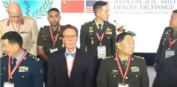  ??  ?? Song (front right) and M. Rauch (front centre), acting US Deputy Assistant Secretary of Defense stand before a photo shoot during the opening ceremony of the Asia Pacific Military Health Exchange 2018, in Xian. — Reuters photo