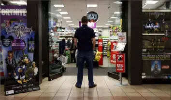  ??  ?? A 27-year-old self-described tech addict stands in front of a video game store at a mall in Everett, Wash. He asked to remain anonymous because he works in the tech industry and fears that speaking out about the negatives of excessive tech use could hurt his career.