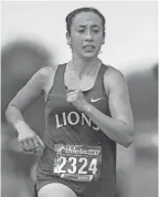  ?? PHOTOS BY ARIA ALA-U-DINI/THISWEEK ?? Gahanna Lincoln's Alyssa Shope competes in the Cross Country Hot Summer Bash at Hilliard Davidson High School in Hilliard on Sept. 4.