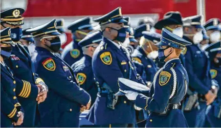  ?? Jon Shapley / Staff photograph­er ?? A member of HPD’s Honor Guard carries a hat to be presented to the family of slain Sgt. Harold Preston during his funeral service. Preston was shot and killed Oct. 20 while helping a woman gather her belongings from her estranged husband’s apartment.