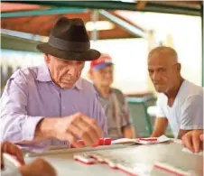  ??  ?? In this file photo, men play dominoes in Miami’s Little Havana neighborho­od.
