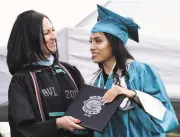  ?? PHOTOS BY CLYDE MUELLER THE NEW MEXICAN ?? Capital High School Principal Channell Wilson-Segura, left, awards a diploma to Guadalupe Avalos, 18. On the way to earning her diploma, the new graduate overcame the loss of her mother to cancer, the family fragmentin­g and moving away and the birth of...