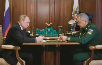  ?? MIKHAIL KLIMENTYEV/SPUTNIK ?? Russian President Vladimir Putin meets with Defense Minister Sergei Shoigu on Monday.