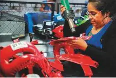  ?? AFP ?? An employee makes protective training headgear at Reyes Industries’ factory in Mexico City.