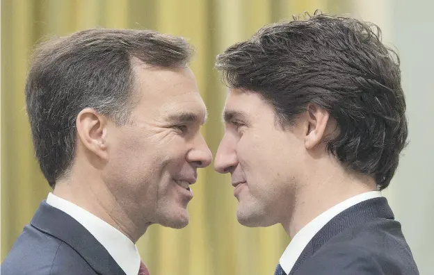  ?? SEAN KILPATRICK / THE CANADIAN PRESS ?? Finance Minister Bill Morneau , left, and Prime Minister Justin Trudeau have their eyes on hiking tax rates for high-income earners.