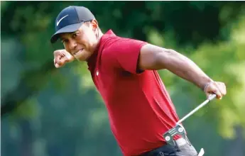  ?? AP ?? Tiger Woods’ final fist pump came after he drained a 19-foot birdie putt on the 18th hole at Bellerive.