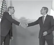  ?? POOL/AFP VIA GETTY IMAGES ?? U.S. Secretary of State Antony Blinken, left, greets Ignazio Cassis, Switzerlan­d’s president and head of the Federal Department of Foreign Affairs, before a meeting in Geneva on Friday.